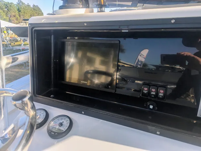  Yacht Photos Pics 2023 Bluewater Sportfishing 23t dashboard with navigation screen and gauges.