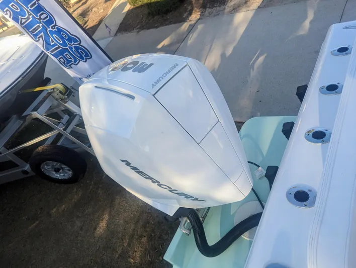 Yacht Photos Pics 2023 Bluewater Sportfishing 23t boat with Mercury outboard motor, displayed outdoors.