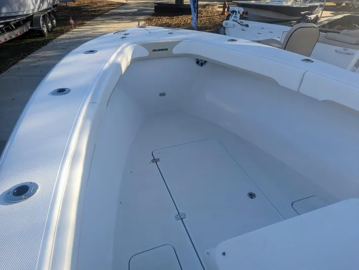  Yacht Photos Pics 2023 Bluewater Sportfishing 23t boat interior, showcasing spacious deck and seating area.