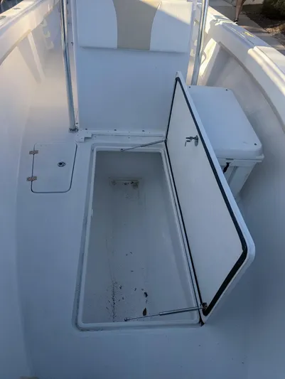  Yacht Photos Pics 2023 Bluewater Sportfishing 23t boat with open storage compartment.