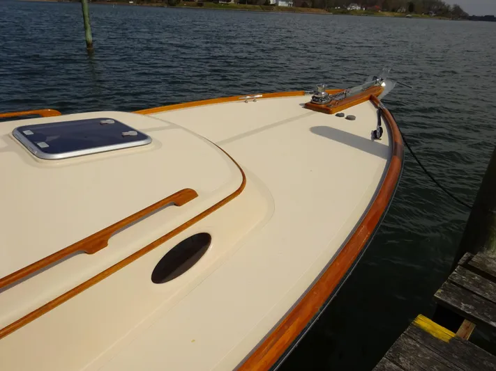 Blue Moon Yacht Photos Pics 1995 Hinckley Picnic Boat Classic docked on calm water, showcasing elegant wooden trim.