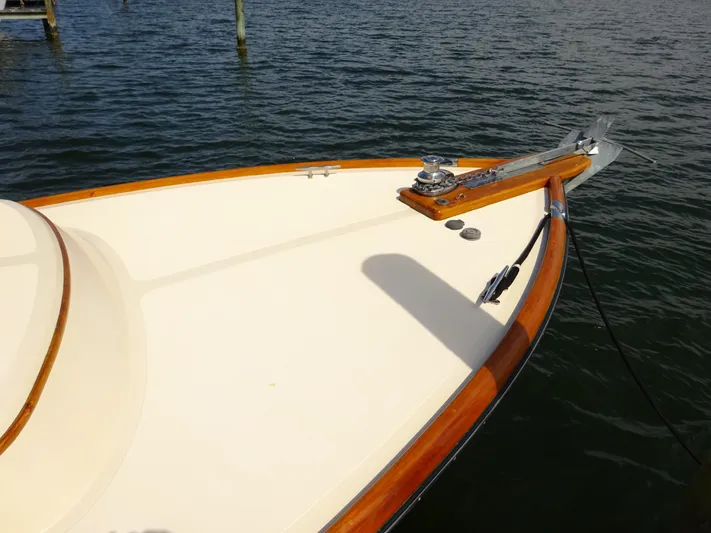 Blue Moon Yacht Photos Pics Hinckley Picnic Boat Classic 1995 bow with wooden trim on calm water.