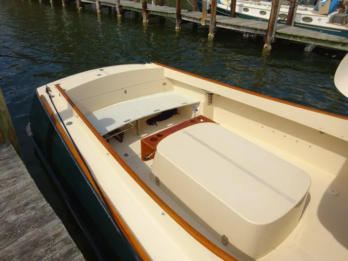Blue Moon Yacht Photos Pics 1995 Hinckley Picnic Boat Classic with beige seating and wooden accents docked by the water.