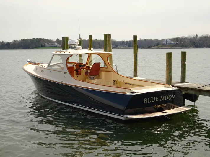Blue Moon Yacht Photos Pics 1995 Hinckley Picnic Boat Classic docked, named "Blue Moon," with elegant design and serene water backdrop.