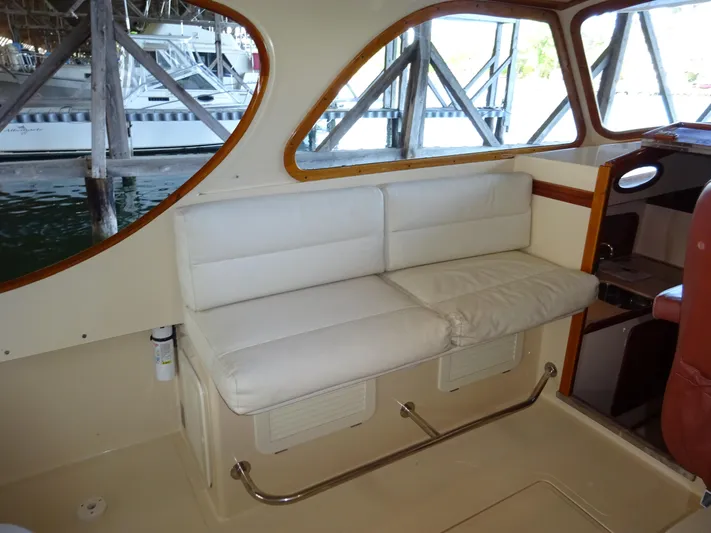 Blue Moon Yacht Photos Pics Interior of 1995 Hinckley Picnic Boat Classic with white cushioned seating.