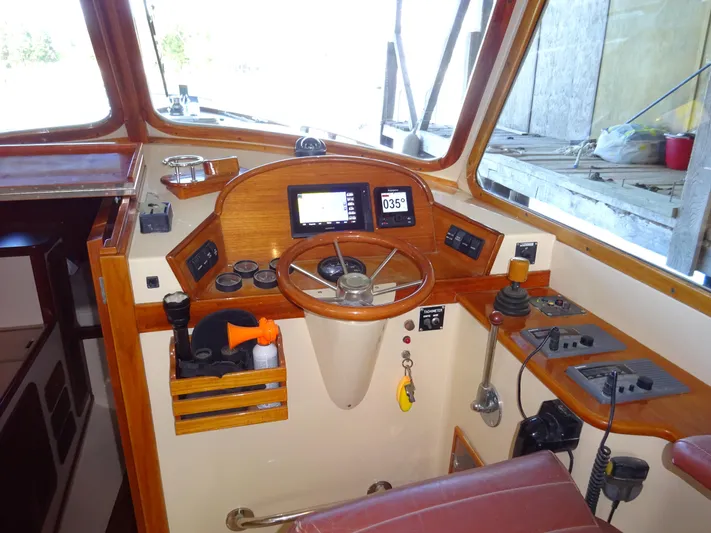 Blue Moon Yacht Photos Pics Helm of 1995 Hinckley Picnic Boat Classic with wooden accents and navigation instruments.