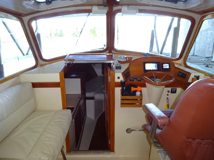 Blue Moon Yacht Photos Pics 1995 Hinckley Picnic Boat Classic interior with helm, seating, and cabin entrance.
