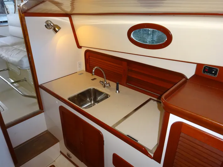 Blue Moon Yacht Photos Pics Interior of 1995 Hinckley Picnic Boat Classic with compact kitchen and sink.