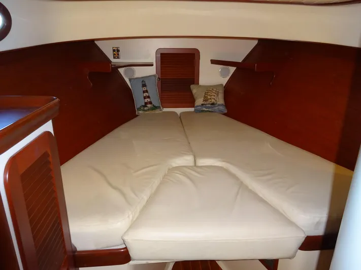 Blue Moon Yacht Photos Pics Interior cabin of 1995 Hinckley Picnic Boat Classic with cozy beige bedding.