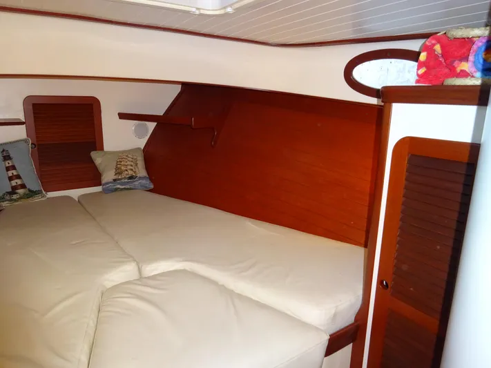 Blue Moon Yacht Photos Pics 1995 Hinckley Picnic Boat Classic cabin interior with cozy bedding and wooden accents.