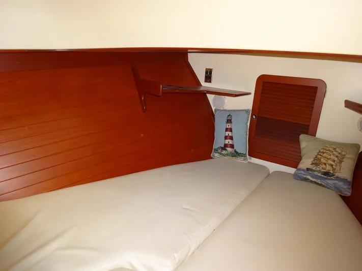 Blue Moon Yacht Photos Pics Cozy cabin interior of 1995 Hinckley Picnic Boat Classic with nautical-themed pillows.