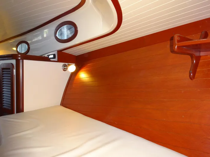 Blue Moon Yacht Photos Pics Interior of 1995 Hinckley Picnic Boat Classic with wood paneling and cozy lighting.