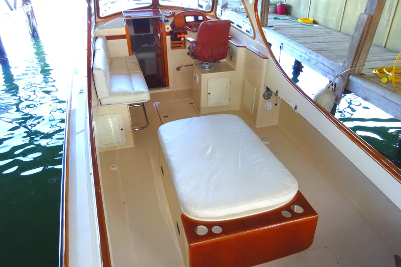 Blue Moon Yacht Photos Pics 1995 Hinckley Picnic Boat Classic interior with seating and helm, docked in a marina.