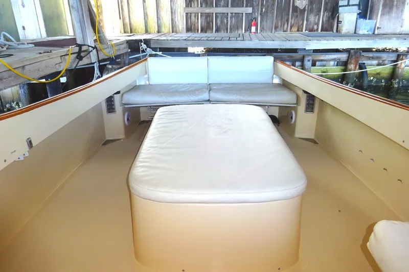 Blue Moon Yacht Photos Pics 1995 Hinckley Picnic Boat Classic interior with cushioned seating and wooden accents.