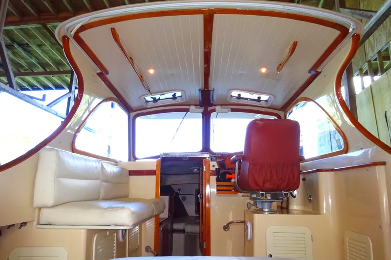 Blue Moon Yacht Photos Pics 1995 Hinckley Picnic Boat Classic interior with red captain's chair and white seating.