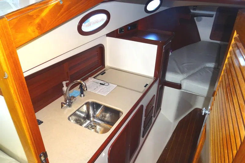 Blue Moon Yacht Photos Pics 1995 Hinckley Picnic Boat Classic interior with kitchenette and cozy seating area.