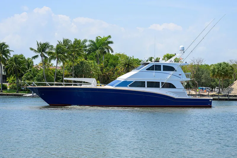 Jr Yacht Photos Pics Luxury 2004 Sea Force IX 82 Enclosed Bridge yacht on calm water, surrounded by palm trees.
