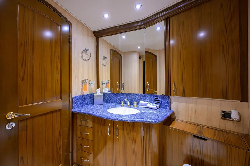 Jr Yacht Photos Pics Luxurious bathroom in 2004 Sea Force IX 82 Enclosed Bridge yacht with wood cabinetry and blue countertop.
