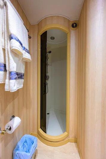 Jr Yacht Photos Pics Shower area in 2004 Sea Force IX 82 Enclosed Bridge yacht, featuring wooden paneling and towels.