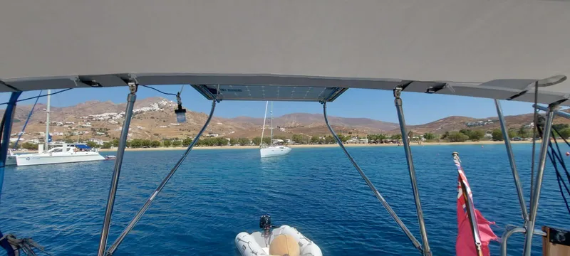  Yacht Photos Pics View from a 2006 Hanse 461 sailboat, overlooking a serene bay with anchored boats.