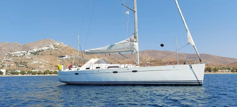  Yacht Photos Pics Sailing yacht Hanse 461, 2006 model, anchored in scenic coastal waters with mountainous backdrop.