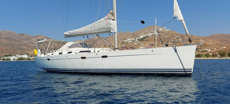  Yacht Photos Pics Sailing yacht Hanse 461, 2006 model, anchored in scenic coastal waters with mountainous backdrop.