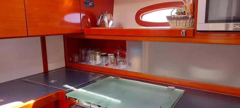  Yacht Photos Pics Modern kitchen interior of 2006 Hanse 461 yacht with wooden cabinets and glassware.