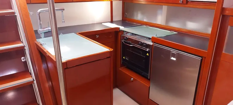  Yacht Photos Pics Modern kitchen in 2006 Hanse 461 yacht with wood cabinetry and stainless steel appliances.