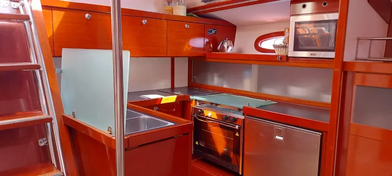  Yacht Photos Pics Luxurious 2006 Hanse 461 yacht kitchen with modern appliances and wooden cabinetry.