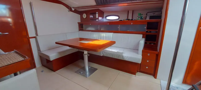  Yacht Photos Pics Interior of 2006 Hanse 461 yacht with modern seating and wooden table.