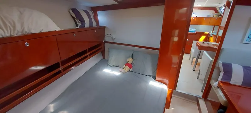  Yacht Photos Pics Cozy cabin interior of 2006 Hanse 461 yacht with plush bedding and wooden finishes.