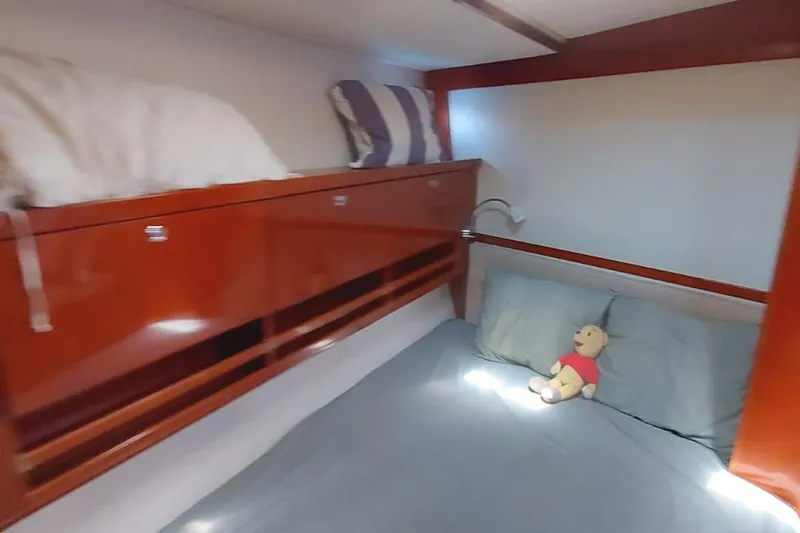  Yacht Photos Pics Cozy cabin interior of 2006 Hanse 461 yacht with plush bedding and wooden storage.