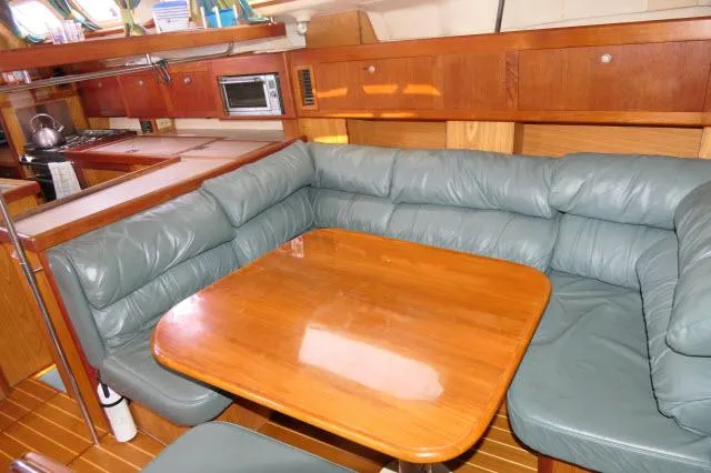 Ale Er Ron Yacht Photos Pics Cozy interior of 2000 Hunter 460 yacht with leather seating and wooden table.