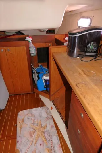 Ale Er Ron Yacht Photos Pics Interior of a 2000 Hunter 460 sailboat with wooden cabinetry and appliances.