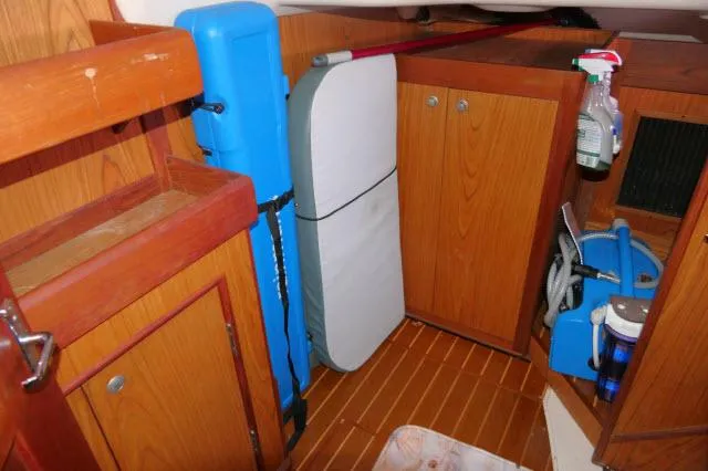 Ale Er Ron Yacht Photos Pics Interior of a 2000 Hunter 460 sailboat with wooden cabinets and storage.