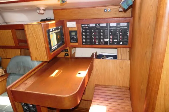 Ale Er Ron Yacht Photos Pics Navigation station in a 2000 Hunter 460 sailboat with control panel and chart plotter.