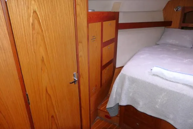 Ale Er Ron Yacht Photos Pics Cozy cabin interior of 2000 Hunter 460 yacht with wooden furnishings and bed.