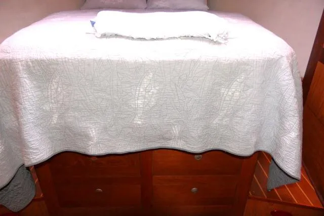 Ale Er Ron Yacht Photos Pics Interior cabin of 2000 Hunter 460 yacht with bed and wooden storage drawers.