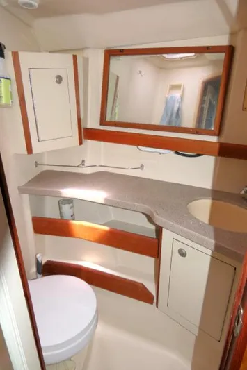 Ale Er Ron Yacht Photos Pics Compact bathroom in 2000 Hunter 460 yacht with sink, mirror, and toilet.