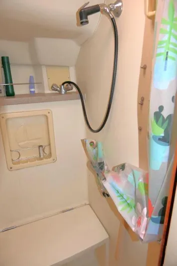 Ale Er Ron Yacht Photos Pics Compact bathroom in 2000 Hunter 460 sailboat with shower and colorful curtain.