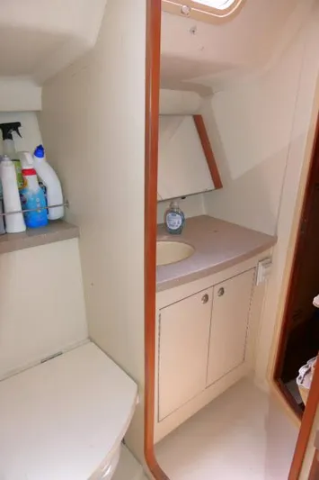 Ale Er Ron Yacht Photos Pics 2000 Hunter 460 yacht bathroom with sink, cabinet, and cleaning supplies.