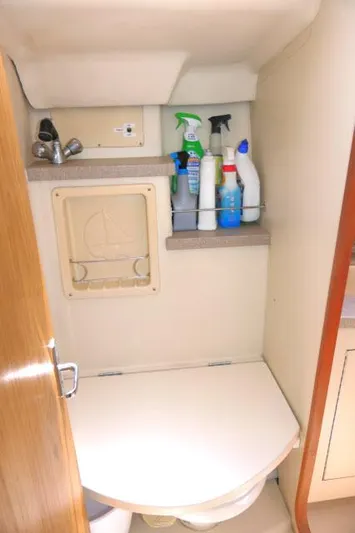 Ale Er Ron Yacht Photos Pics Compact bathroom in 2000 Hunter 460 yacht with cleaning supplies on shelf.