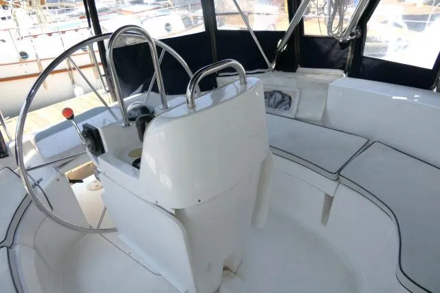 Ale Er Ron Yacht Photos Pics Interior view of 2000 Hunter 460 sailboat cockpit with steering wheel and seating.
