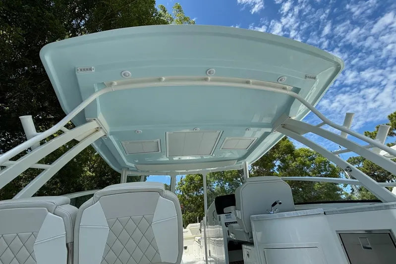 Wcn 51988 325dc Wht Mer350 Yacht Photos Pics 2024 World Cat 325 DC boat interior with seating and canopy.