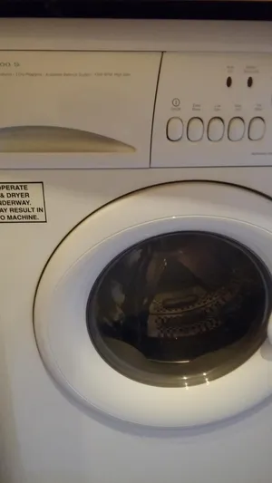 First Light Yacht Photos Pics Front-loading washing machine with control panel and door.