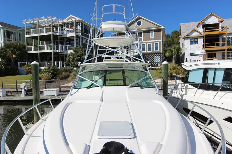 Bloody Knuckles Yacht Photos Pics 2008 Bertram 360 yacht docked at marina, surrounded by modern waterfront homes.