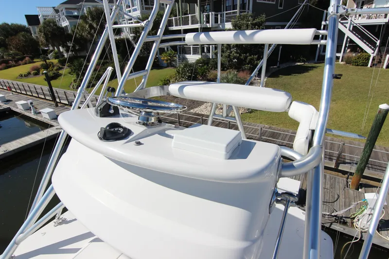 Bloody Knuckles Yacht Photos Pics 2008 Bertram 360 yacht helm station with steering wheel and controls, dockside view.