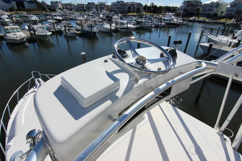 Bloody Knuckles Yacht Photos Pics 2008 Bertram 360 yacht helm overlooking marina with numerous docked boats.