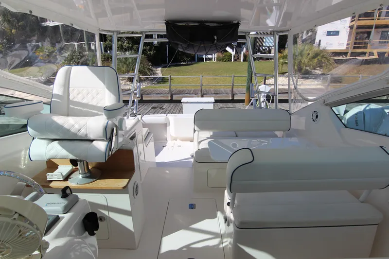 Bloody Knuckles Yacht Photos Pics 2008 Bertram 360 yacht interior with white seating and helm, dockside view.