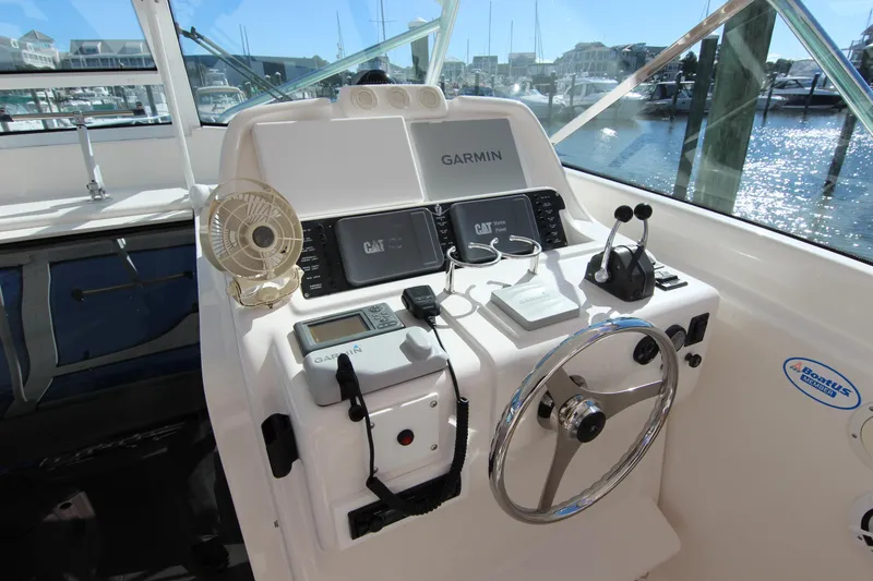 Bloody Knuckles Yacht Photos Pics Helm of 2008 Bertram 360 with Garmin navigation and CAT engine displays.